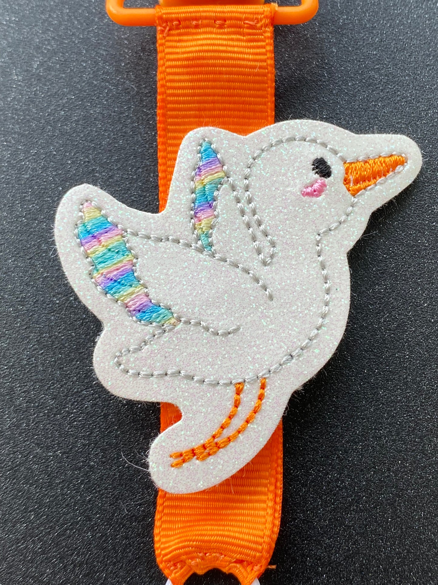 Stork rainbow wings bright orange MRI safe badge clip