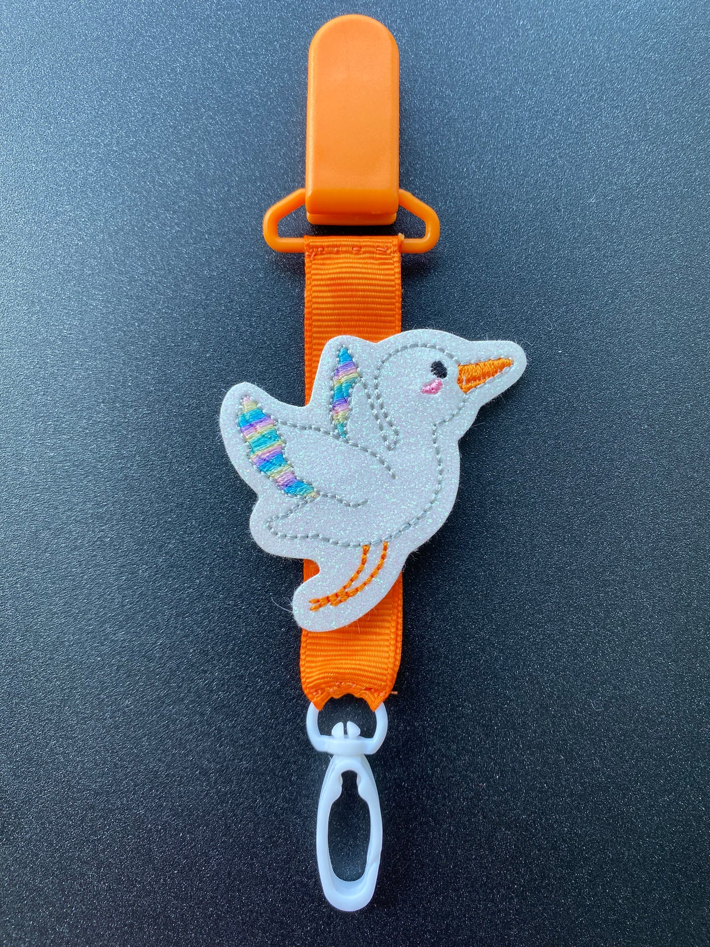 Stork rainbow wings bright orange MRI safe badge clip